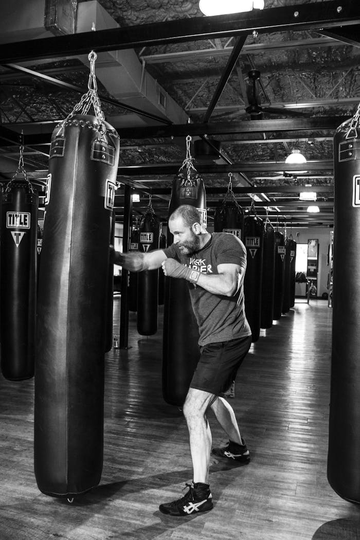 Man Standing Near Heavy Bag